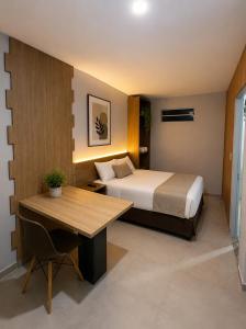 a hotel room with a bed and a wooden table at Hotel SP in Belém