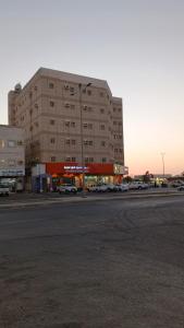 a large building with cars parked in a parking lot at ودان المتميزة in Rabigh