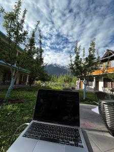 a laptop computer sitting on top of a table at The North Rememberzz in Kalgha