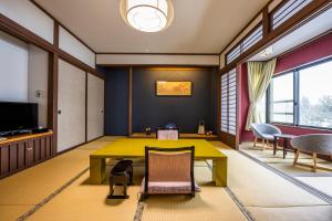 a dining room with a yellow table and chairs at Kanemidori in Kusatsu