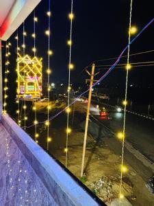 a view of a ferris wheel at night with lights at Hotel SunFort in Rājgīr +9 photos