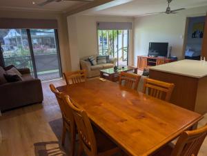 a living room with a wooden table and chairs at Riverside Golf Club in Gol Gol +2 photos