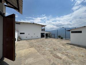 a white building with a view of the mountains at House premium in Macanal