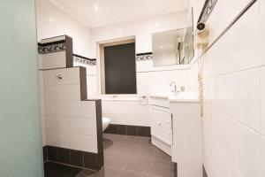 a white bathroom with a sink and a toilet at Georgian Court Inn in Melbourne +43 photos