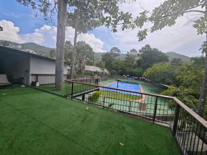 a balcony of a house with a swimming pool at Monkey House Hostel & Guest House Koh Samui in Chaweng Noi Beach