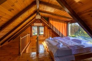 a bedroom in a log cabin with a bed at Via Bungalows Batumi in Batumi