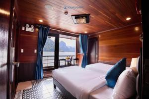 a bedroom with two beds on a boat at Aqua Elegance Cruise - Halong Bay by AHG in Ha Long