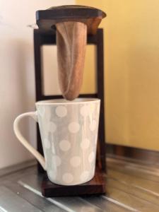 a coffee maker sitting on top of a coffee cup at Casa Malu in Morote +17 photos