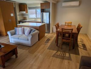 a kitchen and living room with a table and a couch at Riverside Golf Club in Gol Gol