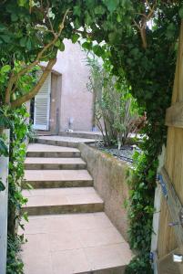 an archway with stairs leading to a building at Les rives de St Tropez in Saint-Tropez