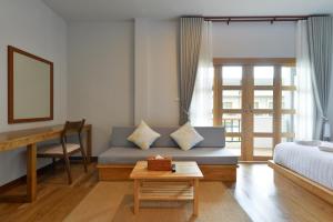 a living room with a couch and a table at Seacrest Boutique Kohtao Thailand in Ko Tao +65 photos