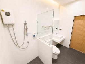 a bathroom with a shower and a toilet and a sink at De Botan Bangna in Bangkok +22 photos