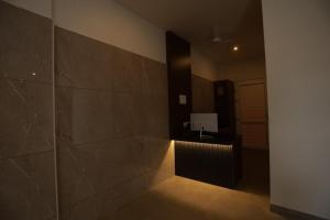 a hallway with a large tile wall and a radiator at Arthana Residency Hotel in Mānuppatti