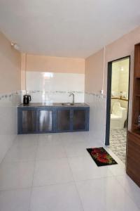 a large kitchen with a sink and a mirror at New Sky Homestay in Chợ Phước Hải