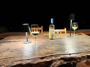 a table with three wine glasses and a bottle of wine at Jua Zuri in Lushoto +54 photos