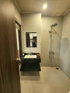 a man taking a picture of a bathroom with a sink at Sunrise Hotel Tại Sầm Sơn in Thanh Hóa +9 photos