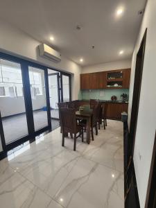 a kitchen and dining room with a table and chairs at Sunrise Hotel Tại Sầm Sơn in Thanh Hóa