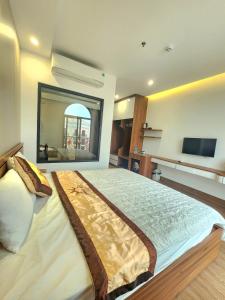 a bedroom with a large bed with a large window at Sunrise Hotel Tại Sầm Sơn in Thanh Hóa