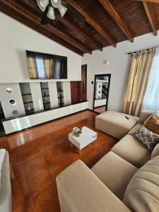 a living room with a couch and a table at Casa luz in Medellín