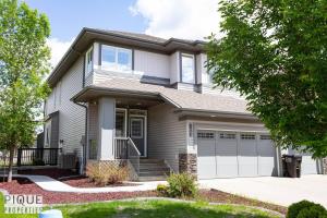 a house with a garage at Spacious Bright Suite - Sleeps 4 - King Bed - NFLX in Edmonton