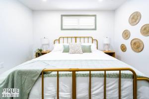 a bedroom with a bed with a metal frame at Spacious Bright Suite - Sleeps 4 - King Bed - NFLX in Edmonton +30 photos