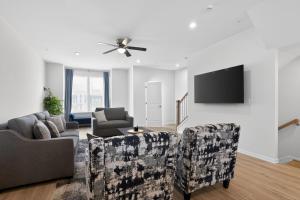 a living room with a couch and chairs and a tv at WYJEK Stays - Riverside Haven in Cambridge