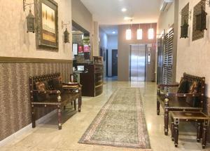 a waiting room with two chairs and a rug at Horizon Hotel Apartments in Dubai