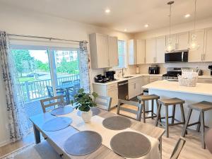 a kitchen with a table and chairs and a large window at WYJEK Stays - Riverside Haven in Cambridge