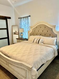 a bedroom with a large bed with a large headboard at My house your house in Fort Smith