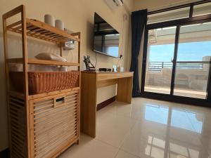 a kitchen with a counter and a sink and a window at 夏米旅宿 in Lukang
