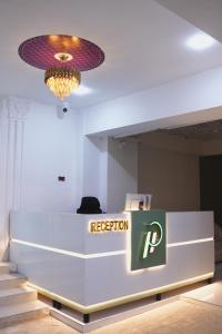 a reception desk in a room with a chandelier at Pc Inn Executive Class Hotel in Sukkur