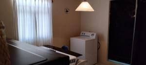 a small room with a refrigerator and a light at Céntrico, seguro, tranquilo y limpio in Ocotlán