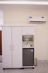 a kitchen with a counter and a refrigerator at Pc Inn Executive Class Hotel in Sukkur
