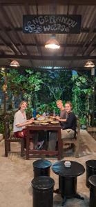a group of people sitting around a table at Hadi Homestay Garden View in Jambu