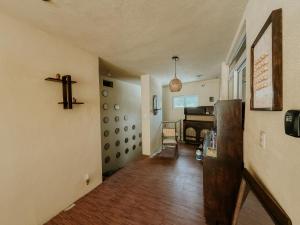 a hallway with a room with a cross on the wall at Zu Suites in San Marcos La Laguna