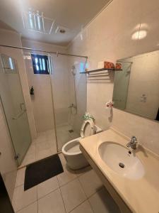 a bathroom with a sink and a shower and a toilet at 夏米旅宿 in Lukang +37 photos