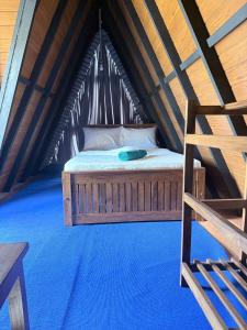 a bed in the middle of a attic at Nelli Kale Holiday Resort in Huratgamuwa