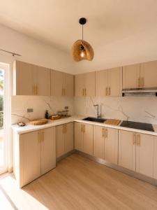 a kitchen with white cabinets and a sink at My tropical home in La Laguna +5 photos