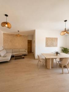 a living room with a couch and a table at My tropical home in La Laguna