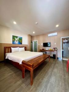 a bedroom with a large bed and a television at Vida Loca Sunset Beach Resort in Phú Quốc