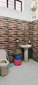 a bathroom with a toilet and a sink at Guru kripa hotel and restaurant in Nīmri