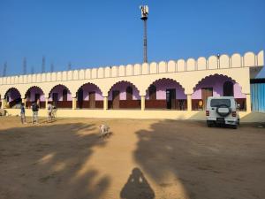 a group of people and a dog in front of a building at Guru kripa hotel and restaurant in Nīmri