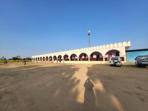 a shadow of a person standing in front of a building at Guru kripa hotel and restaurant in Nīmri