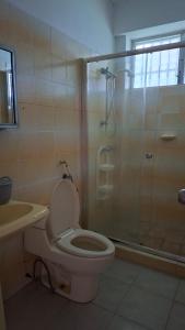 a bathroom with a shower and a toilet and a sink at Casa naranjita in Chame +17 photos