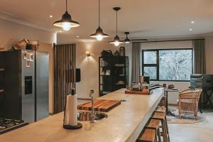 a kitchen with a counter with a sink in it at Lala Lodge in Hoedspruit