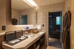 a bathroom with a sink and a shower at みささ in Kyonan