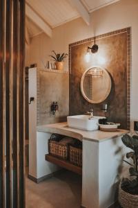 a bathroom with a sink and a mirror at Lala Lodge in Hoedspruit