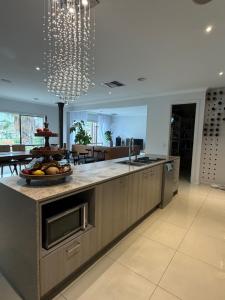 a kitchen with a counter with a bowl of fruit on it at Sunnyhome in Truganina