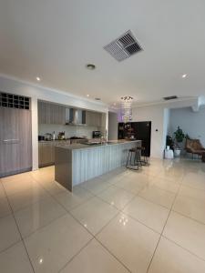 a large kitchen and living room with a counter top at Sunnyhome in Truganina +2 photos