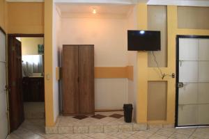 a room with a door and a television on the wall at Terra Vista Hotel in El Guayabo
